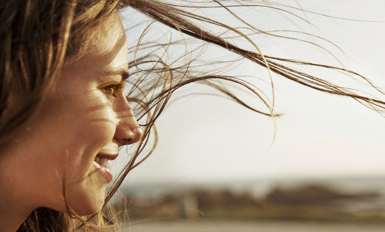 person smiling and looking off to the side