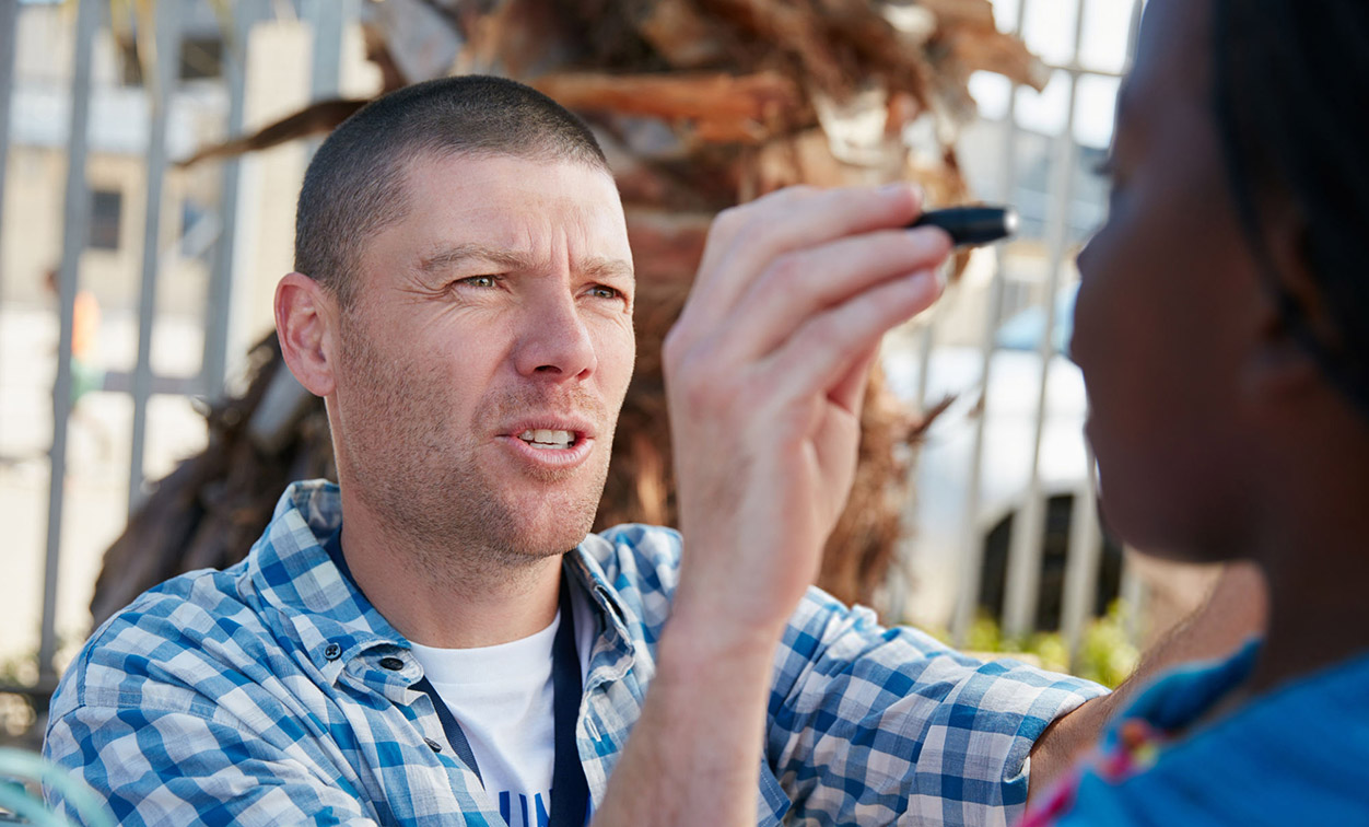 Person Examining eyes of another person
