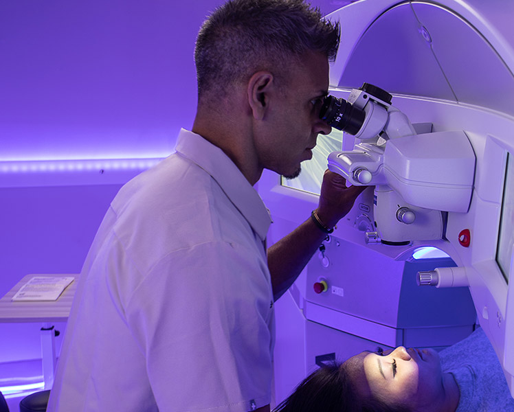 doctor looking into microscope